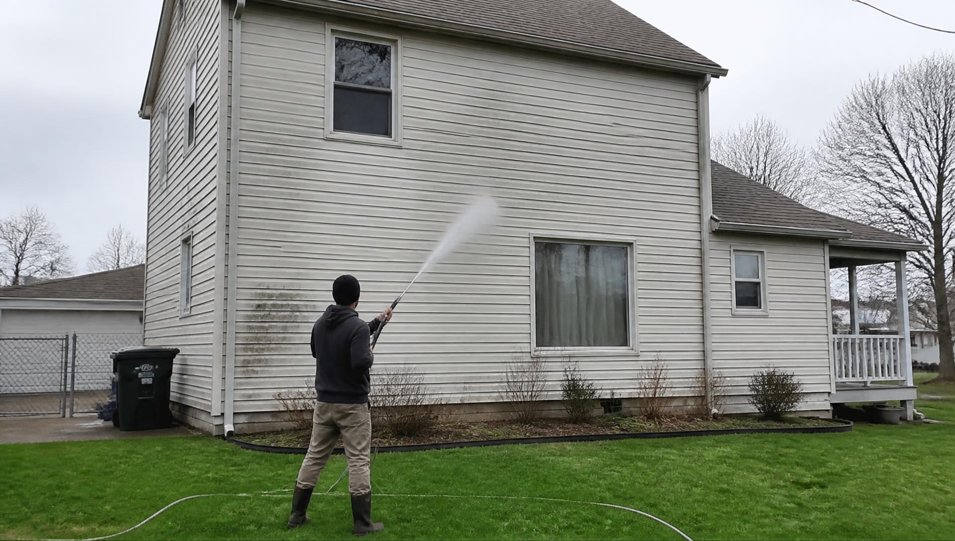 Pressure washing the siding of a suburban home in North Canton, Ohio