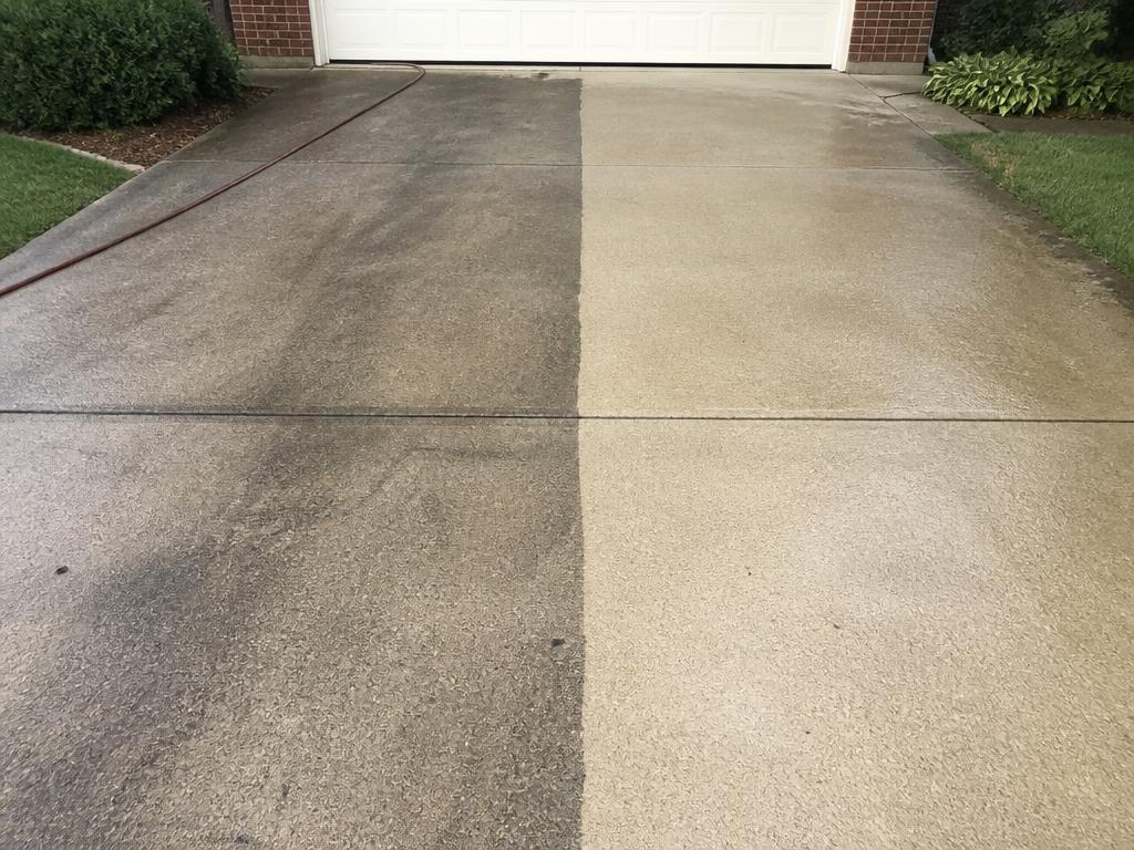 Concrete driveway half pressure washed clean, half still gray with grime